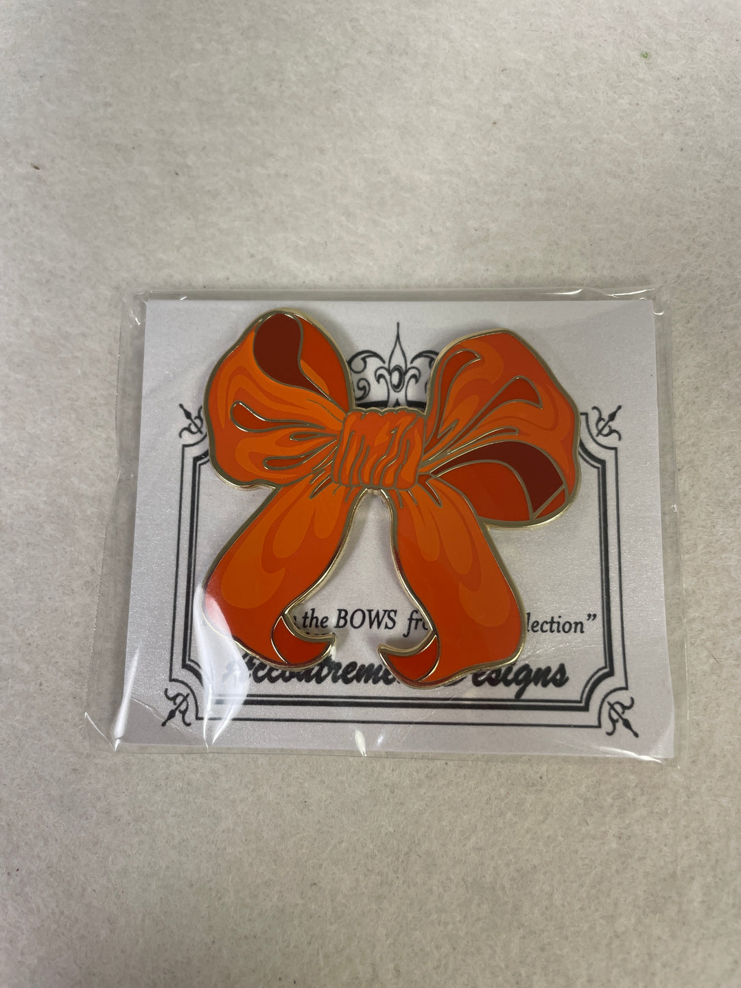 Accoutrement Designs- Orange Bow Needleminder